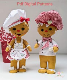 two stuffed dolls are dressed in aprons and hats, one is holding a spoon