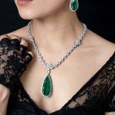 Emerald doublet necklace features beautiful big green gemstone with CZ diamonds in it. Handmade with elegance. Ideal to pair with your bridal gown or any special occasion dress. Perfect gift for her. *𝐏𝐑𝐎𝐃𝐔𝐂𝐓 𝐃𝐄𝐓𝐀𝐈𝐋* * 𝐌𝐚𝐭𝐞𝐫𝐢𝐚𝐥: Brass * 𝐏𝐥𝐚𝐭𝐢𝐧𝐠: White Rhodium Plated * 𝐒𝐭𝐨𝐧𝐞: AAA-quality CZ Diamond & Doublet. *𝐃𝐈𝐌𝐄𝐍𝐒𝐈𝐎𝐍𝐒* *𝐍𝐞𝐜𝐤𝐥𝐚𝐜𝐞* * 𝐖𝐞𝐢𝐠𝐡𝐭: 46 gm * 𝐎𝐧𝐞 𝐬𝐢𝐝𝐞 𝐋𝐞𝐧𝐠𝐭𝐡: 13 Inches * 𝐃𝐫𝐨𝐩 𝐋𝐞𝐧𝐠𝐭𝐡: 0.8 Inches *𝐏𝐞𝐧𝐝𝐚𝐧𝐭 Emerald Statement Necklace, Hollywood Jewelry, Green Pendant Necklace, Emerald Necklace Pendant, American Diamond Necklaces, Pendant Sets, Wedding Pendant, Green Pendants, Paraiba Tourmaline