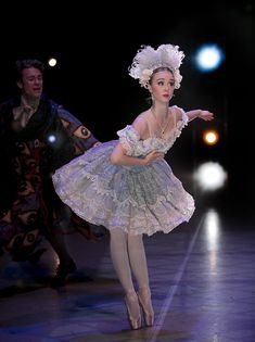 the ballerina is dressed in an elaborate dress