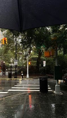 an open umbrella on the street in the rain