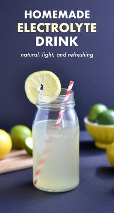 homemade electrolyte drink in a mason jar with lemons and limes around it