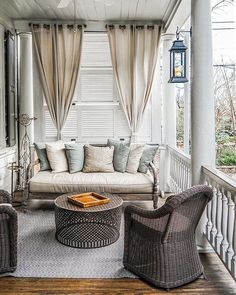 an image of a living room with furniture on the front porch and windows in the back