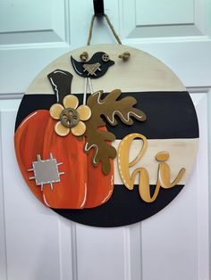 a door hanger decorated with fall decorations