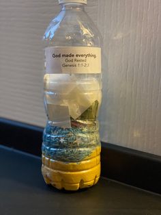 a water bottle with a message on it sitting on a table next to a wall