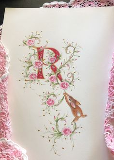 the letter p is decorated with pink flowers and birds on it's back side