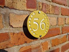 a brick wall with a yellow sign that says 50 on it and the number fifty