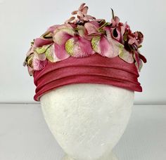 Darling 1960s hat in pink with a crown of velvet petals and formed blooms with silk flower petals. The toque pillbox style hat fits toward the back of  the head, & should fit anyone. 22" around the head  4.5" high 7-8" diameter  A great Spring Easter Hat!  This hat will ship in a box.  Excellent condition no issues arrives ready to wear. We  have many vintage hats in our support store right now. Sale supports Vermont's  PuppeTree. Vintage Pink Fitted Fascinator, Vintage Pink Hat For Evening, Vintage Pink Evening Hat, Vintage Fitted Hat For Ceremonies, Vintage Fitted Hat For Ceremony, Fitted Vintage Hat For Ceremonies, Spring Wedding Retro Fascinator, Accessories Matching, Advance Patterns