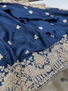 Rise and Shine. A beautiful Pure Satin Silk saree is heavily embellished with hand done Zardozi work. It's a saree which will stand out and it's a must have in your wardrobe this wedding season. Blue satin with Zardosi work make it a very special piece. This saree can be worn for your reception, sangeet or cocktail night and it sure will stand out. Semi-stitched Katan Silk Traditional Wear With Intricate Embroidery, Bollywood Style Unstitched Suit With Zari Work For Reception, Reception Saree Unstitched Suit With Dabka Work, Designer Raw Silk Saree With Dabka Work, Raw Silk Saree With Dabka Work, Festive Raw Silk Saree With Dabka Work, Bollywood Style Unstitched Dola Silk Suit For Reception, Art Silk Unstitched Suit With Intricate Embroidery For Reception, Unstitched Art Silk Suit With Intricate Embroidery For Reception