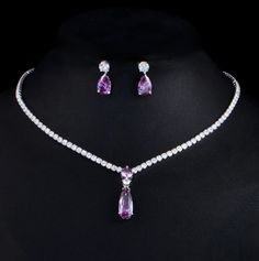 A beautiful two-piece bridal jewelry set with an incredible sparkle! Adorned with intricately faceted purple and clear cubic zirconia that capture the light from every angle with a perfectly translucent appeal, the pieces are platinum plated for a flawless finish which enhances the intricate detailing and conveys a modern take on old elegance. Necklace: 16.5" (approx. 42cm) long with a secure fold-over closure; pendant is 1" (approx. 2.5cm) long. If longer is needed please leave a note at checko Elegant Purple Cubic Zirconia Jewelry, Elegant Purple Jewelry Sets For Formal Occasions, Fine Jewelry Lavender Cubic Zirconia Jewelry, Purple Diamond Necklace For Wedding, Fine Jewelry Lavender Cubic Zirconia, Purple Diamond Necklaces For Wedding, Purple Cubic Zirconia Jewelry With Brilliant Cut, Purple Diamond Wedding Necklace, Purple Brilliant Cut Cubic Zirconia Jewelry