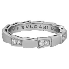 Bvlgari captures the power of seduction in this Serpenti Viper wedding band ring. Sophisticated and glamorous, this ring coils around the finger striking with the precious beauty of the scales. Crafted in lustrous 18K white gold. Total diamond weight: 0.21 carat. Ring size: 54 US 7.25. Band width: 3.5mm. Total weight: 4.93 grams. Made in Italy. Condition: New without tags. Comes with an original box and paper. Power Of Seduction, Bulgari Jewelry, Bvlgari Serpenti, Simple Gowns, Diamond Band Ring, Wedding Band Ring, Diamond Rings Bands, Diamond Band, Diamond Bands