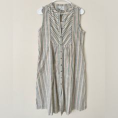 Size Small New With Tags Anthropologie Brand Kopal 100% Cotton Striped Button Down Sleeveless Dress. Handmade In India Cream Sleeveless Dress With Buttons, Sleeveless Beige Midi Dress With Button Closure, Beige Sleeveless Midi Dress With Button Closure, Cream Sleeveless Dress With Button Closure, Chic Striped V-neck Dress, Striped Button-up Relaxed Fit Dress, Striped V-neck Summer Midi Dress, Chic Striped Button-up Dresses, Striped V-neck Cotton Dress