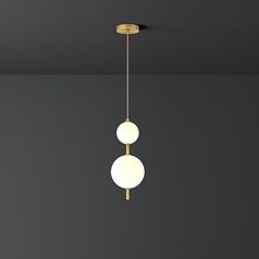 two lights are hanging from the ceiling in a room with dark walls and flooring