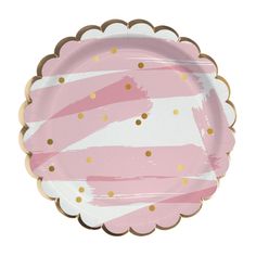 a pink and gold paper plate with scalloped design on the rim, in front of a white background