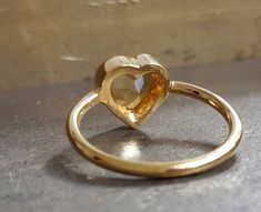 Inspired by a famous graffiti in TLV, the second picture, the citrine heart ring is a trendy choice for anniversaries, engagements, birthdays. Citrine ranges from bright yellow to honey color--one of the Sacral Chakra's essential stones. Positive qualities include making the owner lighthearted and hopeful. It is also associated with prosperity and success, relaxes the body, helping cleanse it of toxins. Birthstone - Scorpio, November Ring - 14k yellow gold, 18k yellow gold, 1.6mm shank Gemstone Heart Cut Rings With Bezel Setting, Yellow Gold Heart Cut Ring With Rose Cut Diamonds, Heart-shaped Bezel Set Ring As Gift, Unique Yellow Gold Birthstone Ring For Anniversary, Handmade Yellow Gold Birthstone Ring For Anniversary, Heart Shaped Wedding Ring With Bezel Setting, Heart-shaped Wedding Ring With Bezel Setting, Heirloom Heart Ring With Birthstone For Gift, Anniversary Yellow Gold Birthstone Ring