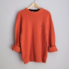 One vintage 1990's pumpkin orange sweater, men's large * Crew neck. * Chevron knit pattern. * Color scheme: pumpkin orange. | SIZE | Marked as a men's Large. ~ Garment laying flat. Double measurements where applicable. ~ Shoulder width: 20 in. * 51 cm. Chest width: 21 in. * 53 cm. Waist width: 18 in. * 46 cm. Length, measured in back: 27 in. * 68.5 cm. | CONDITION | A+. Gently used vintage item. | BRAND | Chaps, by Ralph Lauren. Made in Indonesia. | MATERIALS | 100% cotton. Knit fabric. Orange Winter Sweater With Ribbed Cuffs, Orange Crew Neck Sweater With Ribbed Cuffs, Orange Ribbed Cuff Crew Neck Sweater, Casual Orange Crew Neck Sweater, Casual Burnt Orange Sweater For Fall, Burnt Orange Long Sleeve Winter Sweater, Vintage Orange Sweater For Fall, Pull Orange, Orange Pullover