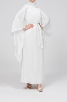 The Eternal Ivory Satin Kimono Sleeve Nikah Maxi Dress is designed for those cherished moments of love and celebration. Crafted from luxurious satin, this dress features a timeless, clean-cut front and gracefully draped extra-long kimono sleeves, offering both elegance and modesty. The detachable belt cinches the waist, creating a flattering silhouette, while the dress's comfortable lining ensures ease of wear. Perfect for special occasions like Nikah or bridal events, this sophisticated maxi dr Modest Activewear, Full Coverage Swimsuit, Bridal Events, Satin Kimono, Bridal Event, Abaya Dress, Kimono Sleeves, Satin Maxi, Long Kimono