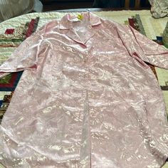 Hundred Percent Polyester Satin Rose Pattern, Five Button Night Shirt With Left Front Pocket Tag Says Mauve I Would Say Pink Armpit To Armpit Measures 22 1/2 Shoulder To Him Measures 35 Inches Pink Button-up Sleepwear For Summer, Pink Sleepwear With Button Closure, Pink Buttoned Tops For Loungewear, Pink Button-up Sleepwear For Loungewear, Pink Button-up Sleepwear For Pajama Party, Pink Sleepwear With Button Closure For Loungewear, Button-up Sleepwear For Pajama Party, Pink Button-up Shirt For Loungewear, Short Sleeve Sleepwear With Buttons