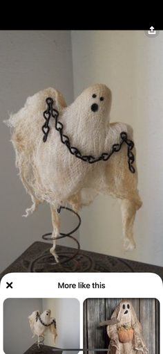 a stuffed animal with chains on it's neck sitting on top of a table