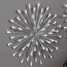 a large metal wall decoration with stars and sparkles on the top, hanging from a gray wall