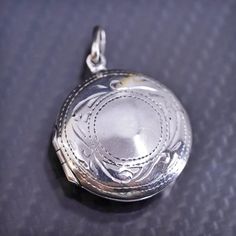 1", Vintage textured circle sterling silver 925 photo locket pendant, stamped 925 Etched Sterling Silver Round Disc Jewelry, Elegant Silver Locket Necklace Stamped 925, Nickel-free Silver Oval Locket Necklace, Nickel Free Sterling Silver Oval Pendant Locket Necklace, Nickel-free Oval Pendant Locket In Sterling Silver, Silver Oval Locket Necklace Nickel-free, Silver Oval Locket Necklace Nickel Free, Silver Jewelry With Oval Coin Pendant, Hallmarked Sterling Silver Round Disc Jewelry