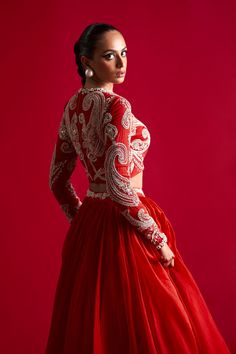 Editor's Note A serene traditonal look in this flowy skirt matched with hand embroidered pattern blouse. Fabric: Organza Color: Red Component: Skirt, blouse and dupatta Occasion: Engagement Care: Dry Clean Only About the DesignerBhumika Sharma is a luxury women’s wear label that molds ethnic materials in contemporary styles. The ensembles have a strong ethical influence with exquisitely handcrafted embroideries doused in artisanal embellishments and luxurious fabrics. Luxury Red Chanderi Blouse Piece, Luxury Blouse With Dupatta For Traditional Ceremonies, Luxury Traditional Blouse For Diwali, Luxury Red Blouse Piece With Sheer Dupatta, Luxury Blouse Piece With Intricate Embroidery For Diwali, Luxury Embroidered Blouse Piece For Diwali, Luxury Red Designer Wear Choli, Luxury Red Choli For Transitional Season, Luxury Red Choli For Diwali