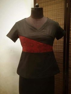 a woman's dress on display in front of a wall