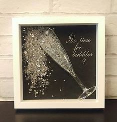 a black and white photo with glitter in it on a table next to a brick wall