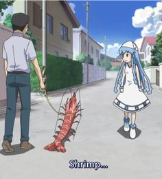 a man and woman walking down a street next to a dead lobster