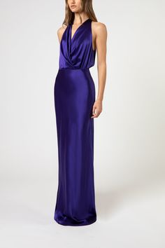 Plunge neckline halter gown in pure silk charmeuse. Features a full length bias cut skirt with an invisible zipper closure at back. Made in USA. Composition: 100% silk Jewel Tone Dress, Purple Evening Gowns, Purple Silk Dress, Lace Wedding Guest Dress, Draped Gown, Drape Gowns, Bias Cut Skirt, Halter Gown, Column Dress