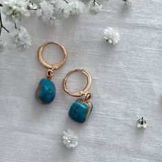 Turquoise Gold Encased Drop Earrings  ☾ ﾟ｡⋆ Details ⋆｡ ﾟ☾ Stone size: Approximately 1cm This listing is for one pair of earrings. The turquoise stones are excellent quality and absolutely stunning. Please note, the stones are organic in shape, as each is charmingly unique, she size and shape of each stone may vary. ☾ ﾟ｡⋆ How to care for your jewellery ⋆｡ ﾟ☾ Although our jewellery is made of high quality materials made to last, to ensure longevity we recommend the following care tips: ● Avoid showering, swimming, and exercising with our pieces ● Polish your pieces every 2 weeks or so, to increase shine and reduce discoloration ● Avoid wearing perfumes with your jewelry ● When not in use, store items in the pouch included in the order ☾ ﾟ｡⋆ Your future awaits ⋆｡ ﾟ☾ In every order, we include Blue Drop Earrings As Gift For Her, Blue Dangle Earrings As A Gift For Her, Elegant Everyday Turquoise Earrings, Nickel-free Blue Earrings As Gift For Her, Elegant Turquoise Hypoallergenic Hoop Earrings, Nickel Free Blue Earrings As Gift For Her, Turquoise Jewelry With Matching Earrings As Gift, Blue Single Earring As Gift, Elegant Turquoise Hoop Earrings