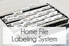 a file cabinet with labels on it and the words home file labeling system in front