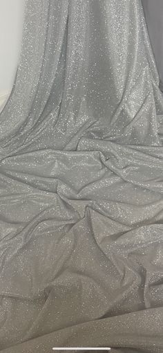 "WHITE/SILVEE MOONLIGHT GLITTER STRETCH FABRIC Product information 1 mtr white/silver moonlight glitter stretch fabric 58\" wide 147cm Moonlight fabrics are a excellent stunning material that is perfect to create beautiful stylish garments. Moonlight material is a sheer fabric with a eye catching sparkle effect that will make up to a beautiful evening wear creations such as skirts and blouses. Ideal for decorations,dress making,bridal,over laying fabric,waistcoats,jackets,table runners,crafts, d Metallic Sequin Fabric With Shimmer For Evening, Metallic Shimmer Sequin Fabric For Evening, Silver Glitter Sequin Fabric For Party, Stretch Sequin Fabric With Shimmer For Evening, Silver Shimmer Sequin Fabric For Wedding, Silver Glitter Sequin Fabric For Party Season, Fitted Silver Sequin Fabric With Shimmer, Elegant Silver Sequin Fabric With Glitter, White Glitter Sequin Fabric For Evening