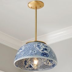 a blue and white lamp hanging from the ceiling