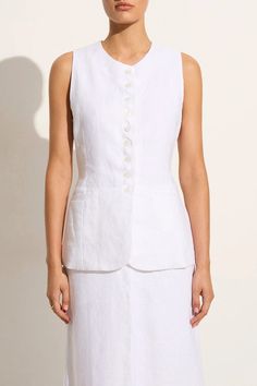 Softly tailored in 100% linen, the Domenico Vest Top in White is a feminine, vintage-inspired silhouette featuring a high round neckline, button front detail and an adjustable back strap to cinch at desired. Finished with a side pocket detail and fully lined for extra coverage. Fitted Unlined Linen Dress, Fitted Linen Dress With Button Closure, Fitted Linen Dress With Buttons, Fitted Casual Linen Dress Unlined, Classic Fitted Linen Dress For Daywear, White Linen Dress For Workwear, White Linen Dress For Work, Elegant White Linen Dress With Buttons, Elegant Fitted Linen Dress With Button Closure