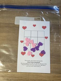 a piece of paper that has hearts cut out of it on top of a table