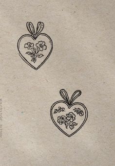 two hearts with flowers are drawn on paper