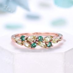 a ring with green and white stones on it