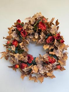 a wreath made out of dried leaves and flowers