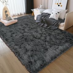 a bedroom with a large gray rug on the floor