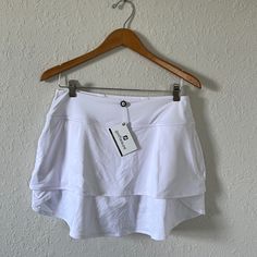 New With Tags Footjoy Layered Golf Skort. Never Worn. Size Medium. White Sports Skirt For Summer, White Sport Skirt For Summer, White Sports Swim Skirt, Skirted Tennis Shorts For Summer, White Skirted Swim Skirt For Sports, White Tennis Skirt With Built-in Shorts For Summer, White Athleisure Mini Skirt, White Tennis Skirt For Summer, White Athleisure Mini Skirt For Summer