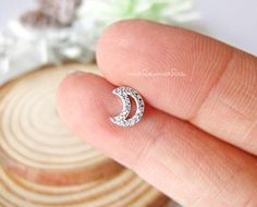 * Sparkly Crescent Moon CZ Ear Piercing, 16G Cartilage earrings, Surgical Steel.⚠️This listing is for ONE piece, NOT a pair ⚠️* Materials : Post - 316L Surgical Steel , Top - Copper with Nickel-Free plating, long lasting color.* Closure type :  Screw Ball back* Dimensions:   Moon 6.5 x 7.5 mm* Post length : 6 mm* Bar thickness : 16 gauge (1.2 mm)* Ball back size : 16G / 3 mm **Measurements are an approximation. Size, shape and color can vary slightly from above dimensions.**★★★ Get extra ball ba Moon Shaped Cartilage Earring As Gift, Moon Shaped Cartilage Earring For Gift, Moon Shaped Single Cartilage Earring As Gift, Internally Threaded Crescent Piercings As A Gift, Internally Threaded Crescent Piercings For Gift, Gift Moon Shaped Single Cartilage Earring, Hypoallergenic Moon-shaped Cartilage Earrings As Gift, Ear Piercings Gauges, Black Hoops Earrings