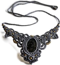 BLACK ONYX'S PROTECTIVE POWER: The centerpiece of each necklace is the ethically sourced Black Onyx, a stone celebrated for its protective qualities and ability to offer strength in challenging times. This gemstone is a powerful ally, enhancing personal energy and fostering emotional resilience, transforming every piece into not just an accessory, but a guardian. MASTERFUL ARTISANSHIP: Immerse yourself in the realm of unparalleled craftsmanship with AYANA's Handmade Macrame Necklace, intricately fashioned from premium cotton cord for ultimate comfort and a gentle touch. This piece is a testament to eco-conscious artistry, skillfully combining sustainable methods with traditional fabric and thread craftsmanship. Each necklace is a unique, limited edition piece, embodying the distinct and na Bohemian Onyx Pendant Necklaces, Handmade Spiritual Onyx Necklace, Spiritual Onyx Natural Stone Necklace, Spiritual Black Onyx Necklace, Black Bohemian Crystal Pendant Necklace, Personal Energy, Emotional Resilience, Challenging Times, Gentle Touch