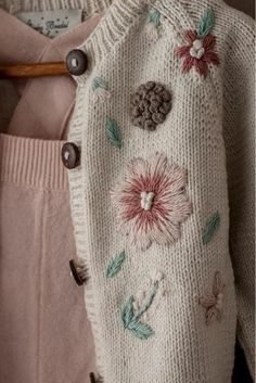 a close up of a sweater with flowers on it