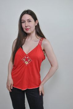 Check out this floral red tank top made of mixed synthetic fabric with flowers embroidery. Good choice for summer festival outfit. Great relaxed top for hippie vibe. Welcome to TARASCOMMON.ETSY.COM Unique clothing from the 20th century. Model tall - 170cm. Size: M. Width - 46cm / 18.11inch; Length - 60cm / 23.62inch. All measurements are taken seam to seam while lying flat. Viscose/ Elastan. This item is vintage, so it can have some defects. Additional photos can be send We are glad that you are Summer Hippie V-neck Top, Orange V-neck Top For Festivals, Orange Sleeveless Summer Vest, Orange Sleeveless Vest For Summer, Red Summer Camisole For The Beach, Red Summer Camisole For Beach, Summer Beach Camisole In Red, Red Tank Top For Spring Vacation, Red Camisole For Summer Beach Party