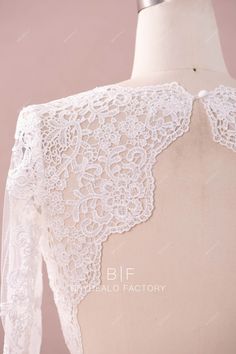 This designer bridal bolero is made out of beautiful flower lace and illusion tulle underneath, featuring exquisite scalloped lace trim adored along the boat neckline, long sleeve cuffs, edge of front bodice and the open back. It will match perfectly with bridal pantsuits and skirts in any silhouette. shown color light ivory bra support no boning no closure back button lining no lining Luxury Wedding Lace Top With Scalloped Lace, Luxury Fitted Lace Top With Scalloped Lace, Long Sleeve Lace Bolero, Long Sleeve Lace Crop Top, Luxury White Lace Top With Scalloped Lace, Lace Bolero Wedding Long Sleeve, Bridal Pantsuit, Bridal Bolero, Illusion Tulle