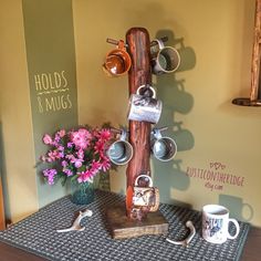 a wooden sculpture with cups and mugs on it