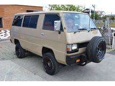 a tan van is parked on the street