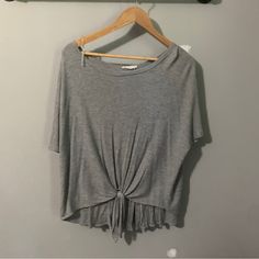 Oversized Knit T Shirt From A Boutique With Some Really Cute Details. It Ties In The Front And Has Wooden Buttons Up The Back. It Is Size Small But It Fits Very “Oversized”. In Brand New Condition Trendy Short Sleeve Knit Top For Loungewear, Casual Oversized Short Sleeve Knit Top, Casual Gray Loungewear Top, Gray Crew Neck Tops For Day Out, Casual Gray Cotton Knit Top, Gray Casual Tops For Layering, Casual Gray Knit Top With Short Sleeves, Gray Casual Knit Top For Spring, Casual Gray Knit Top For Spring