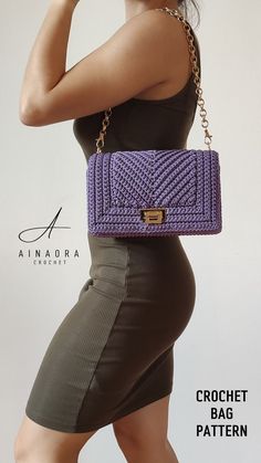 a woman is holding a purple purse