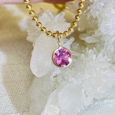 Featuring a natural and earthmined tourmaline with a gorgeous pink hue, and a round brilliant cut The fine gem is bezel wrapped solid 14K yellow gold with a round bail on top.  The bail has a 3mm inner diameter, round, but can be squeezed a little bit to make it more oval if necessary. The pendant is 9mm long x 6mm wide It can be worn alone or paired with another pendant. Pink Round Cut Tourmaline Jewelry, Pink 14k Gold Round Cut Jewelry, 14k Gold Pink Gemstone Jewelry, Pink 14k Gold Jewelry With Gemstone Accents, Gold Tourmaline Jewelry With Bezel Setting, Pink Gemstone Accents Round Necklace, Pink 14k Gold Jewelry With Bezel Setting, 14k Gold Pink Solitaire Jewelry, Round Pink Sapphire Jewelry In Pink Gold